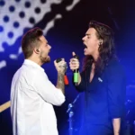 Liam Payne and Harry Styles singing together on stage in 2015Credit Getty