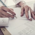 Retro toned image of accountant summing up the numbers