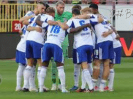 dynamo – schalke -a group of football players huddling on a field