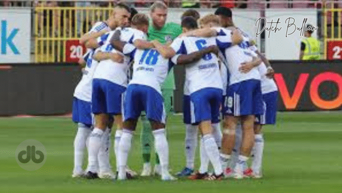 dynamo – schalke -a group of football players huddling on a field