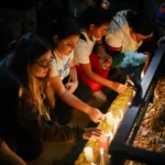 fans-place-candles-outside-hotel